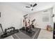 Personal gym featuring free weights, a seated weight machine, and an exercise bike at 9574 Meadow Hunt Way, Winter Garden, FL 34787