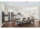 Bright kitchen with white cabinetry, granite counters, stainless steel appliances, and a large island at 9574 Meadow Hunt Way, Winter Garden, FL 34787