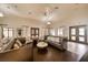 A spacious lounge features stylish furniture and ample natural light for comfortable gatherings at 9574 Meadow Hunt Way, Winter Garden, FL 34787