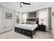 Comfortable main bedroom featuring tile floors, decorative wall art, and a large window at 9574 Meadow Hunt Way, Winter Garden, FL 34787