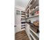 Walk-in pantry with custom shelving and ample storage space for kitchen essentials at 9574 Meadow Hunt Way, Winter Garden, FL 34787