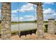 Scenic view of a serene lake with a charming stone swing, perfect for relaxation and enjoying nature at 9574 Meadow Hunt Way, Winter Garden, FL 34787