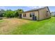 A well-maintained backyard featuring a large grassy area and the back of a home at 1023 Hermosa Way, Kissimmee, FL 34744