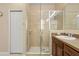 Bathroom featuring a tiled walk-in shower with glass doors and a single vanity at 1023 Hermosa Way, Kissimmee, FL 34744