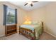 Cozy bedroom with a ceiling fan, natural light, and simple decor at 1023 Hermosa Way, Kissimmee, FL 34744