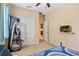 Bedroom featuring a twin bed, an elliptical machine, and double door closet at 1023 Hermosa Way, Kissimmee, FL 34744