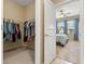 View of the closet and door that enters to a bedroom with a ceiling fan and a window at 1023 Hermosa Way, Kissimmee, FL 34744