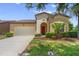 Charming single-Gathering home with a well-maintained lawn, mature landscaping, and attached two-car garage at 1023 Hermosa Way, Kissimmee, FL 34744