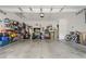 Spacious garage with overhead storage, tool cabinets, bicycles and painted white walls at 1023 Hermosa Way, Kissimmee, FL 34744
