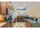 Modern kitchen features stainless steel appliances, granite countertops, and an open design leading to the dining area at 1023 Hermosa Way, Kissimmee, FL 34744