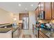 Modern kitchen featuring stainless steel appliances, granite countertops, and ample cabinet space at 1023 Hermosa Way, Kissimmee, FL 34744