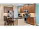 Modern kitchen with granite countertops, stainless steel appliances, and dark wood cabinets at 1023 Hermosa Way, Kissimmee, FL 34744