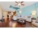 Spacious living room with hardwood floors that transitions to the kitchen with bar seating at 1023 Hermosa Way, Kissimmee, FL 34744