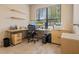 Well-lit home office with built-in shelving, a large window, and wood-look tile flooring at 1023 Hermosa Way, Kissimmee, FL 34744