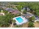 Aerial view of a community pool with bathhouses, lounge chairs, and lush landscaping, offering a relaxing atmosphere at 1023 Hermosa Way, Kissimmee, FL 34744