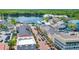 Stunning aerial view of colorful townhomes, tree-lined street, and picturesque lake in a vibrant community at 1131 Indigo Dr, Celebration, FL 34747
