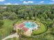 Aerial view of a community pool, lush landscaping, and recreational area with palm trees at 1131 Indigo Dr, Celebration, FL 34747
