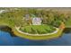 Expansive aerial view features manicured lawns, lakeside amenities, and community spaces surrounded by mature trees at 1131 Indigo Dr, Celebration, FL 34747
