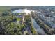 Scenic aerial view showcases lakeside community with amenities, lush greenery, and picturesque waterfront at 1131 Indigo Dr, Celebration, FL 34747