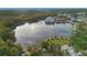 High angle aerial view features a picturesque lake, community amenities, and scenic views of the surrounding landscape at 1131 Indigo Dr, Celebration, FL 34747