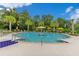 Expansive community pool featuring ample seating, palm trees and a relaxing atmosphere at 1131 Indigo Dr, Celebration, FL 34747