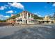 Charming exterior of building featuring decorative columns, street view, and pedestrian crossing under bright blue sky at 1131 Indigo Dr, Celebration, FL 34747