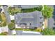 Aerial view of a home with a dark roof, landscaped backyard, and a wooden deck at 1131 Indigo Dr, Kissimmee, FL 34747