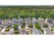 Aerial view of a residential community surrounded by lush greenery and trees, showcasing neighborhood layout at 1131 Indigo Dr, Kissimmee, FL 34747
