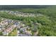 Beautiful aerial view of a community nestled among mature trees with a pond nearby at 1131 Indigo Dr, Kissimmee, FL 34747