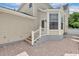Home featuring brick paved patio and a back door leading inside at 1131 Indigo Dr, Kissimmee, FL 34747