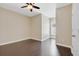 Neutral bedroom featuring a ceiling fan and hardwood floors, offering a serene and inviting space at 1131 Indigo Dr, Kissimmee, FL 34747