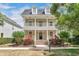 Inviting two-story home featuring a covered front porch and an upper-level balcony at 1131 Indigo Dr, Kissimmee, FL 34747