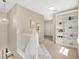 Upstairs hallway features a decorative light fixture and a built-in bookshelf at 1131 Indigo Dr, Kissimmee, FL 34747