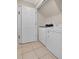 Functional laundry room features tile flooring, modern washer and dryer, and ample space at 1131 Indigo Dr, Kissimmee, FL 34747