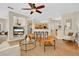 Open living room with modern furniture, hardwood floors, and a view of the kitchen at 1131 Indigo Dr, Kissimmee, FL 34747
