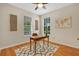 Bright office featuring a ceiling fan, natural light, wood floors, and a decorative rug at 1131 Indigo Dr, Kissimmee, FL 34747