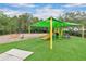 Outdoor playground area offers turf, shade canopy, and fun play structures at 1131 Indigo Dr, Kissimmee, FL 34747
