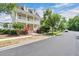 Beautiful street view of a two-story house with a balcony, framed by lush trees at 1131 Indigo Dr, Kissimmee, FL 34747