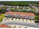 Charming townhomes with red tile roofs are nestled in a well-maintained community with lush green landscaping at 1180 S Beach Cir, Kissimmee, FL 34746