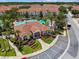 Aerial view of community clubhouse, pool, and meticulous landscaping with a vibrant, welcoming atmosphere at 1180 S Beach Cir, Kissimmee, FL 34746