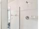 White tiled walk-in shower with glass door and chrome fixtures at 1180 S Beach Cir, Kissimmee, FL 34746