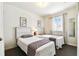 Inviting bedroom featuring twin beds, a window with natural light, and neutral decor at 1180 S Beach Cir, Kissimmee, FL 34746