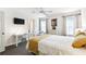 Comfortable bedroom features a wall-mounted TV and a ceiling fan at 1180 S Beach Cir, Kissimmee, FL 34746