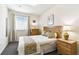 Cozy bedroom with a full-sized bed, neutral color palette, and natural light from the window at 1180 S Beach Cir, Kissimmee, FL 34746