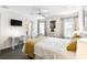 Comfortable bedroom features a wall-mounted TV and a ceiling fan at 1180 S Beach Cir, Kissimmee, FL 34746