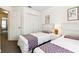 Bright bedroom featuring twin beds, closet, and neutral decor in a well-lit space at 1180 S Beach Cir, Kissimmee, FL 34746