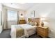 Cozy bedroom with a full-sized bed, neutral color palette, and natural light from the window at 1180 S Beach Cir, Kissimmee, FL 34746