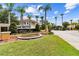 Fiesta Key community entrance sign surrounded by palm trees and well-maintained landscaping under a blue sky at 1180 S Beach Cir, Kissimmee, FL 34746