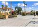 Gated entrance to the community with well-maintained landscaping and palm trees on a sunny day at 1180 S Beach Cir, Kissimmee, FL 34746
