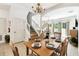 Inviting dining area boasts natural lighting and comfortable seating, perfect for entertaining or Gathering meals with stairs in background at 1180 S Beach Cir, Kissimmee, FL 34746